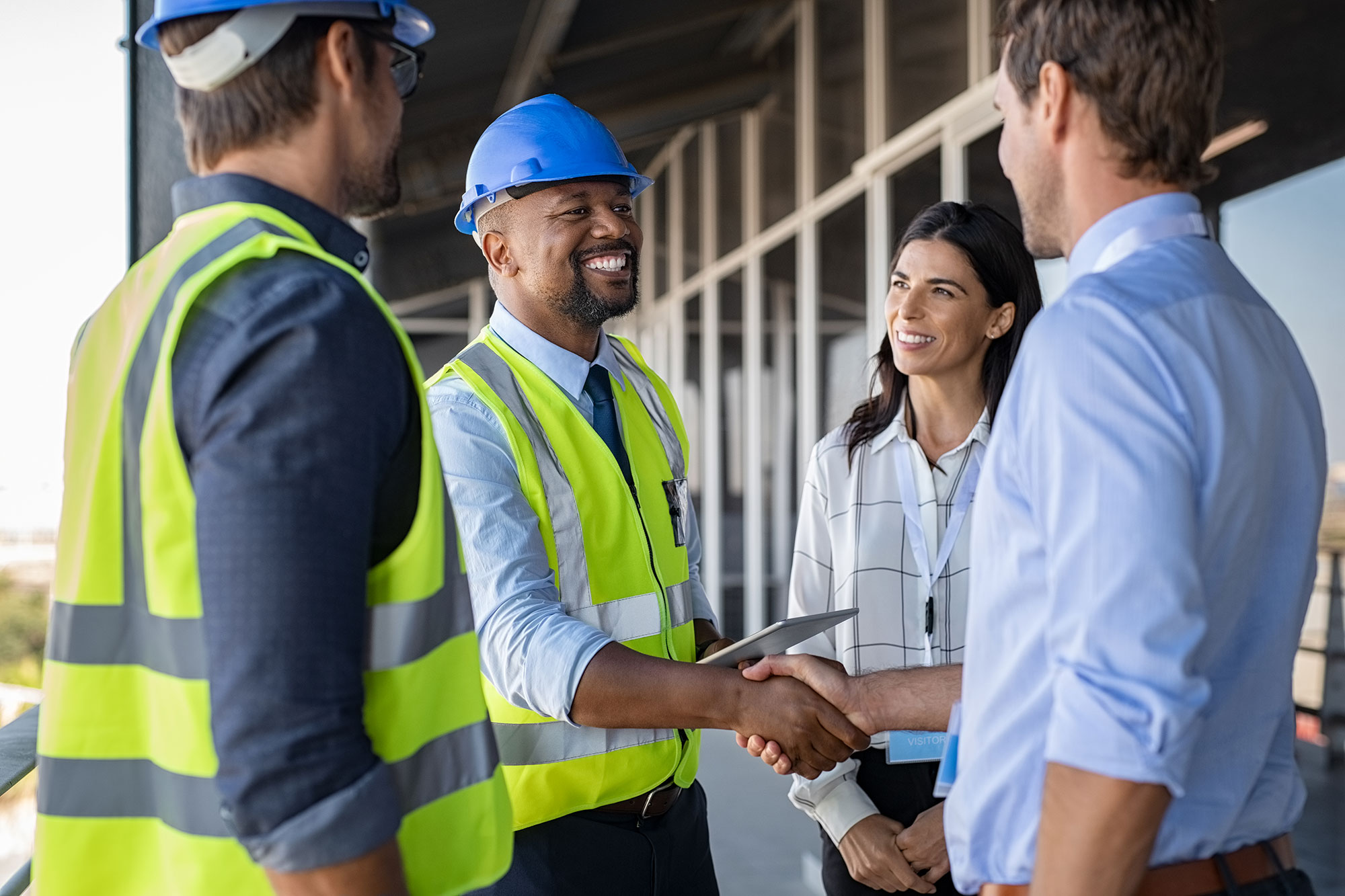 people shaking hands at construction site