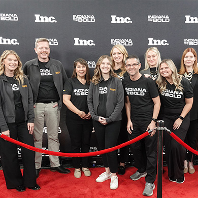Posed group in front of red chord